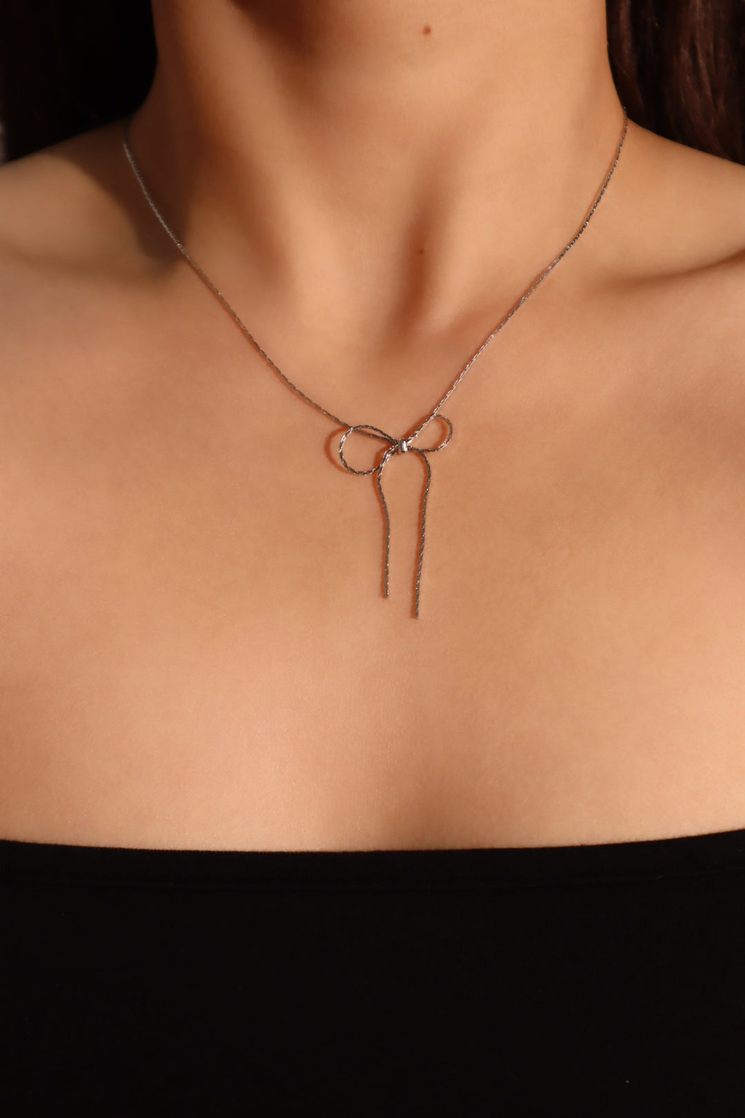 Collana con fiocco in acciaio inossidabile