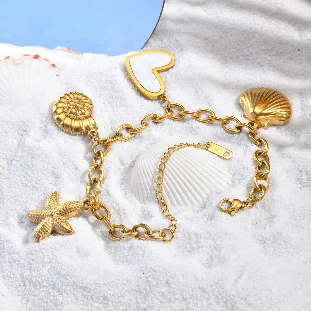 Bracciale in oro con conchiglie e stelle marine per donna